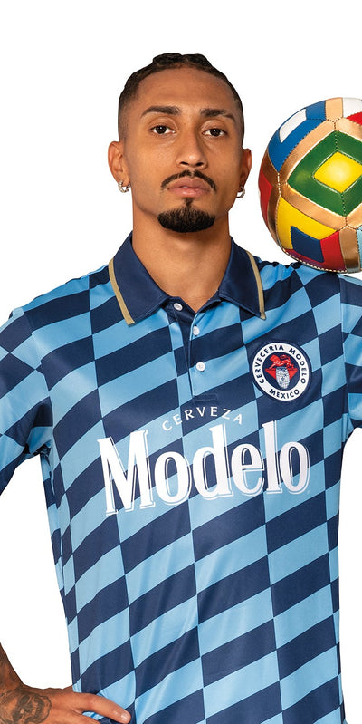 Raphina wearing a blue and white striped soccer jersey with 'Modelo' branding, holding a soccer ball.
